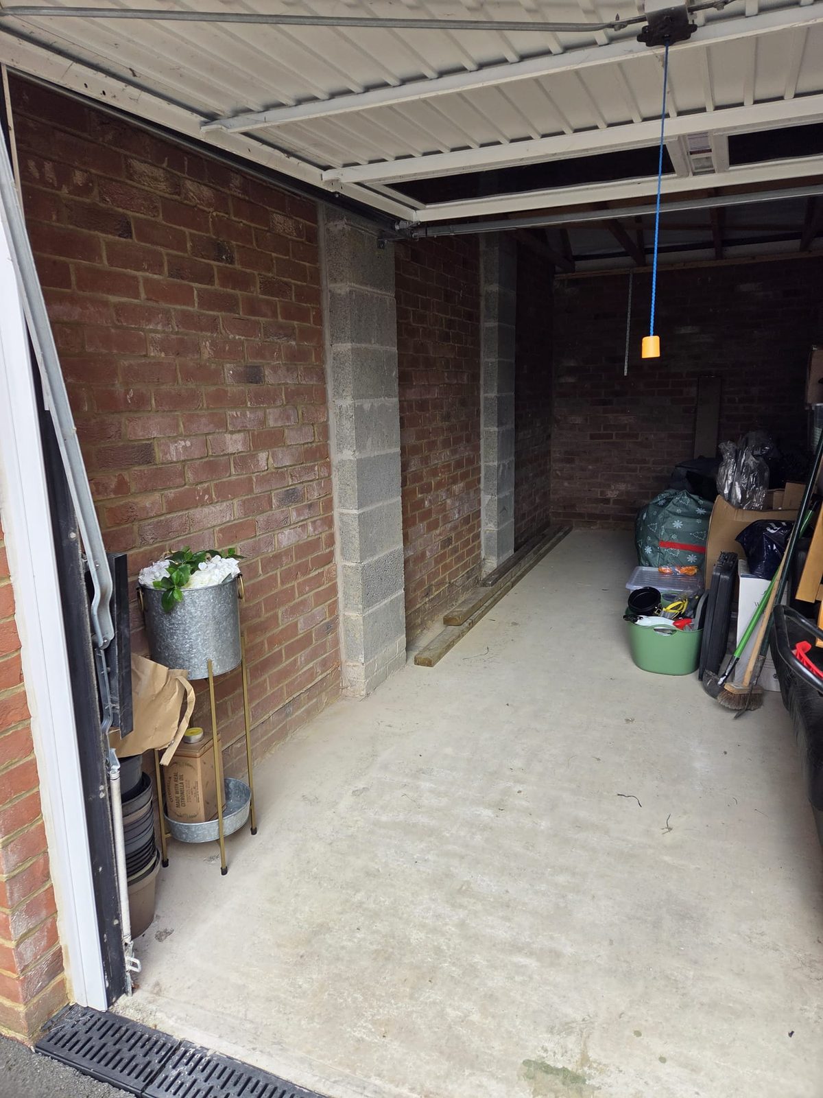 Detached garage before electrical installation, bare pendant light, no sockets, no consumer unit