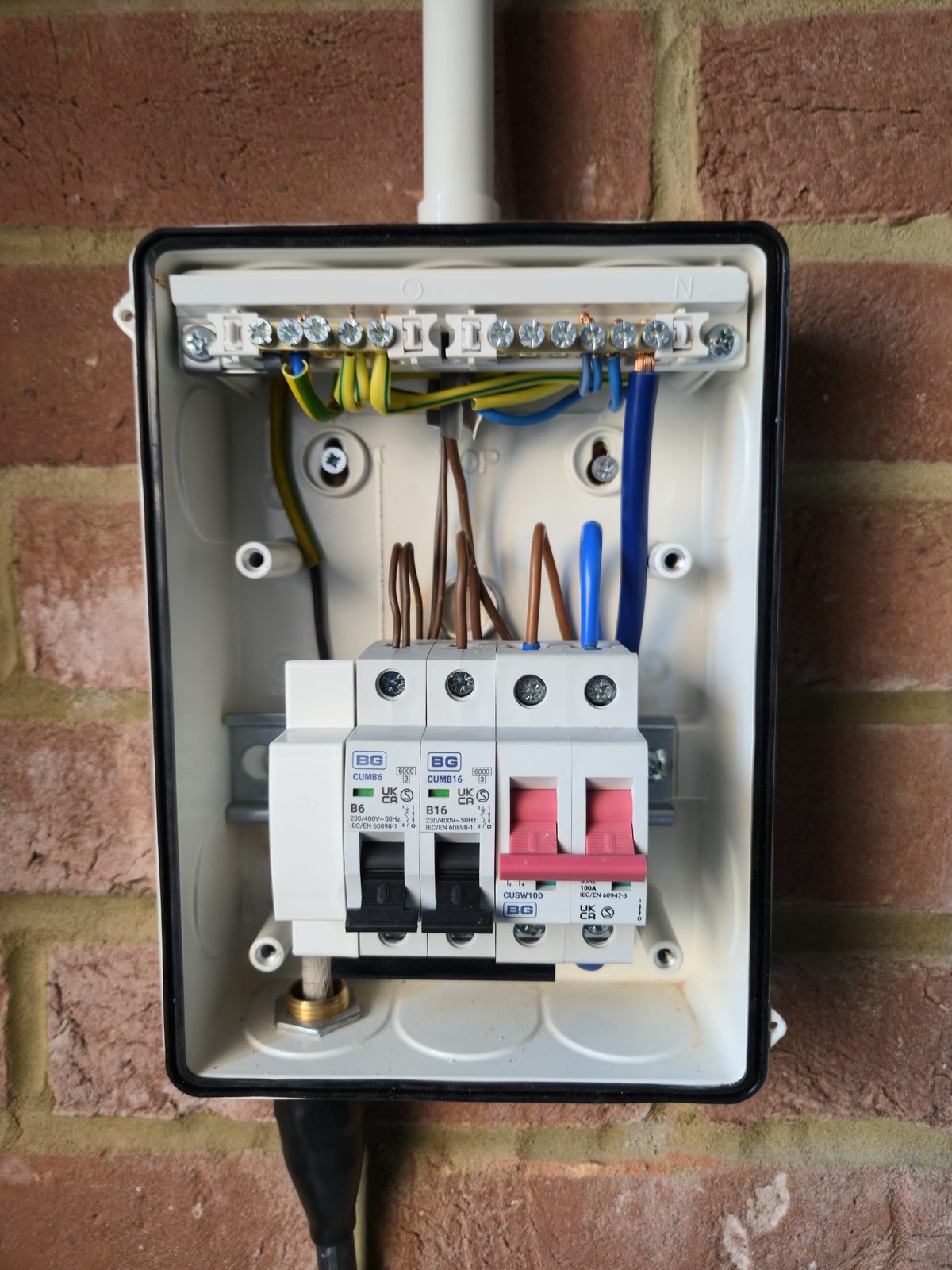 Inside the BG consumer unit, 100A main switch, B16 and B6 MCBs, tidy wiring
