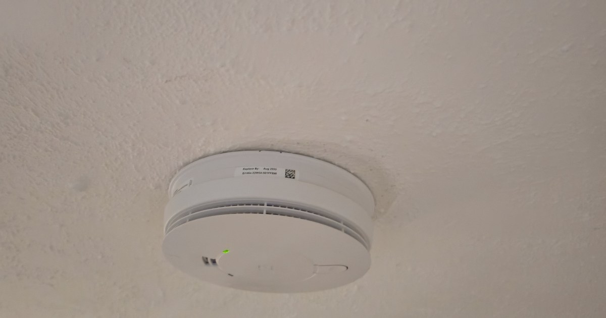 Hardwired interlinked smoke alarm installed on a hallway ceiling in a York terraced house