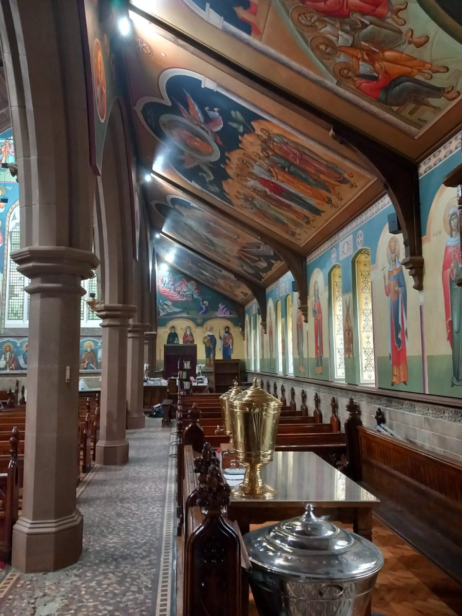 Church nave with inadequate lighting, artwork colours washed out