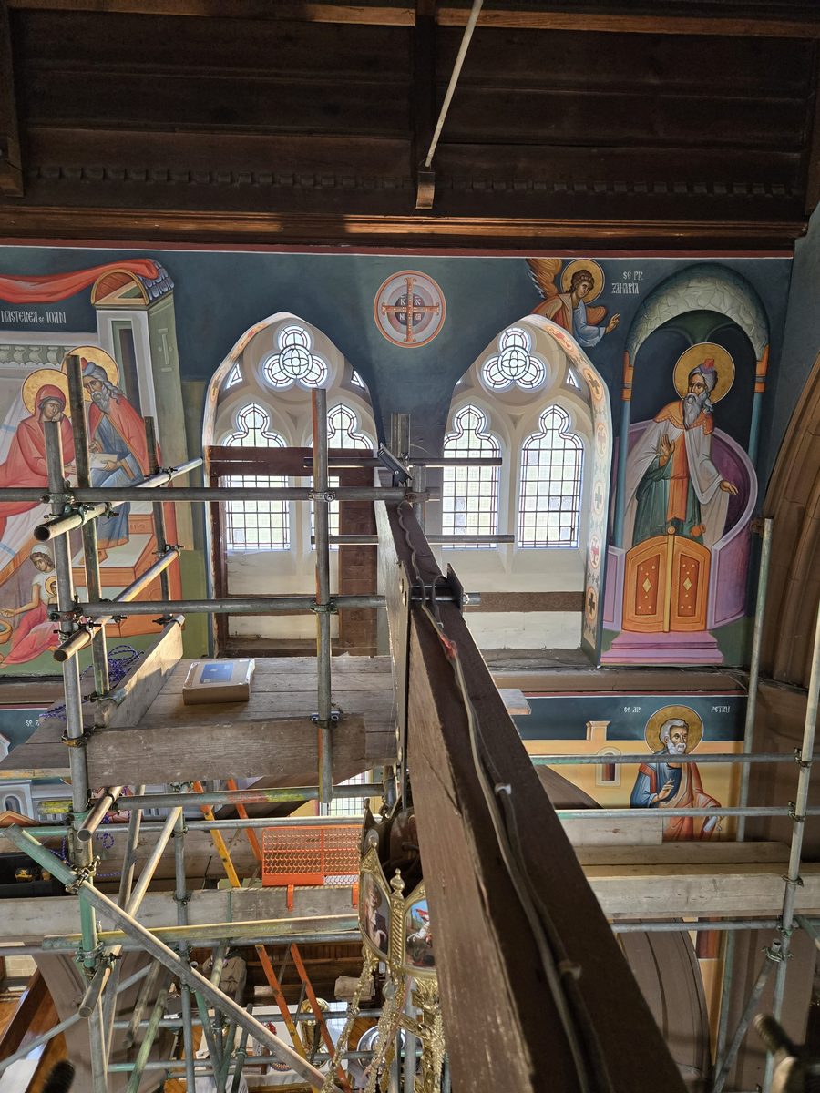Working on scaffold walkways at height alongside hand-painted murals