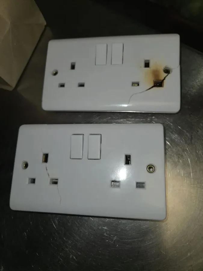 Two removed LAP double sockets showing burn damage and cracking